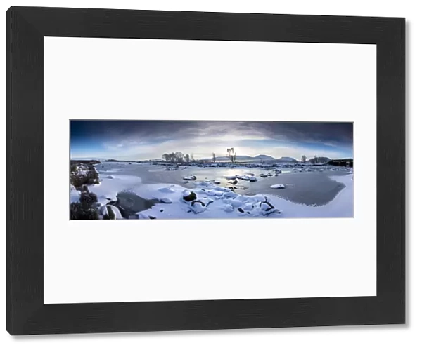 Panoramic winter view over frozen Loch Ba at dawn, Rannoch Moor, Highland