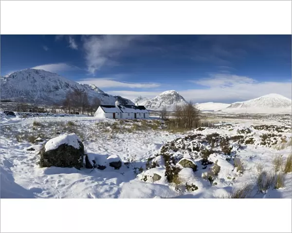Panoramic view of Black Rock Cottage with Buachaille Etive Mor in distance on snow covered Rannoch Moor, near Fort William, Highland, Scotland, United