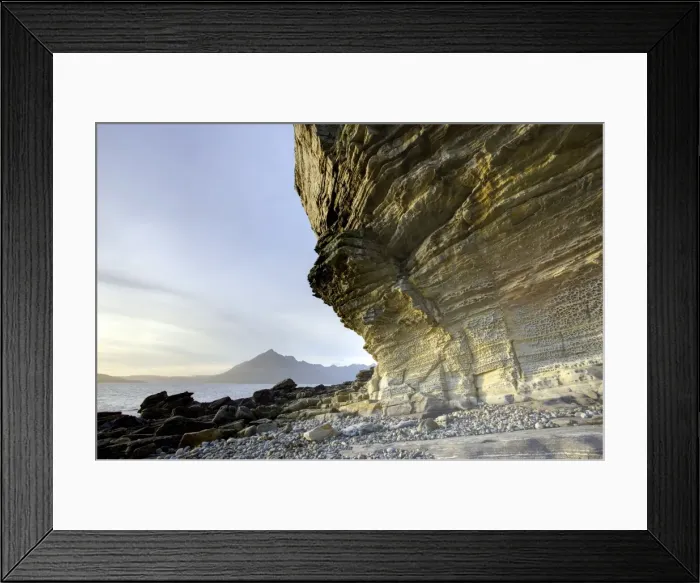 Framed Print : Honeycombe Rock bathed in evening light with Cuillin Hills in distance Framed Print : Honeycombe Rock bathed in evening light with Cuillin Hills in distance