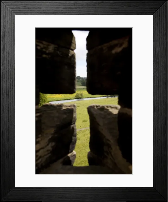 Framed Print : River Aln seen through arrow slit of the walls of Alnwick Castle, Northumberland Framed Print : River Aln seen through arrow slit of the walls of Alnwick Castle, Northumberland