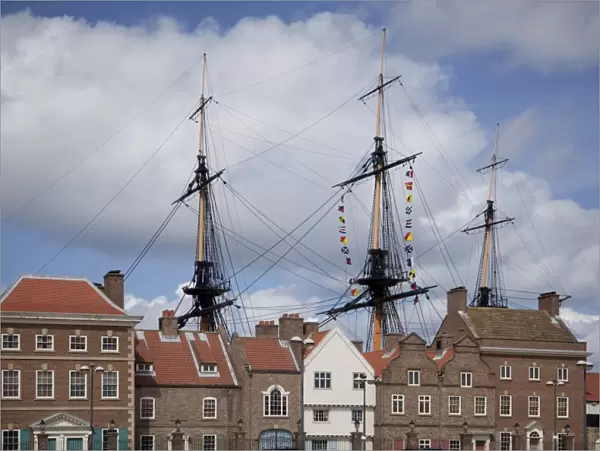 Masts and rigging of HMS Trincomalee, British Frigate of 1817, seen above old buildings at Hartlepools Maritime Experience, Hartlepool, Cleveland, England, United