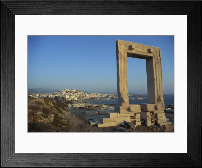 Framed Print : Roman arch at archaeological site with sea and village in the background Framed Print : Roman arch at archaeological site with sea and village in the background