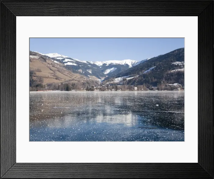 Framed Print : Frozen Zeller See lake with snow capped mountains reflected in ice in alpine resort Framed Print : Frozen Zeller See lake with snow capped mountains reflected in ice in alpine resort