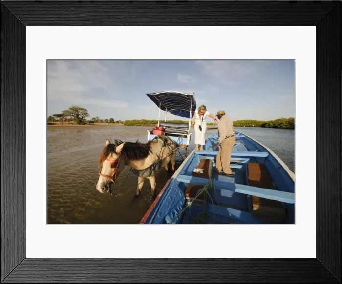 Framed Print : Delivering passangers to pirogue or fishing boat on the backwaters of the Sine Saloum delta Framed Print : Delivering passangers to pirogue or fishing boat on the backwaters of the Sine Saloum delta