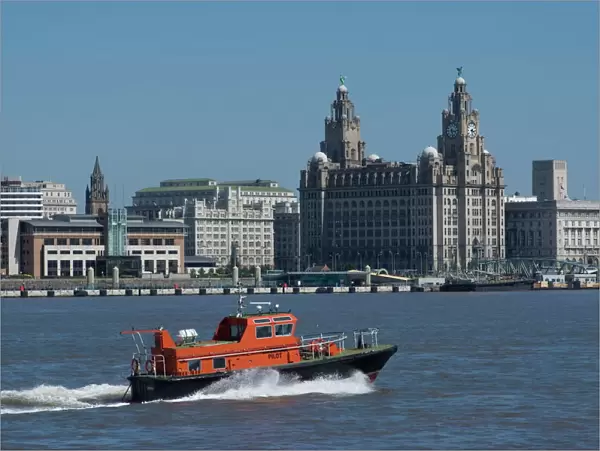 View of the Liverpool skyline and the Liver building, with a pilot boat in the foreground