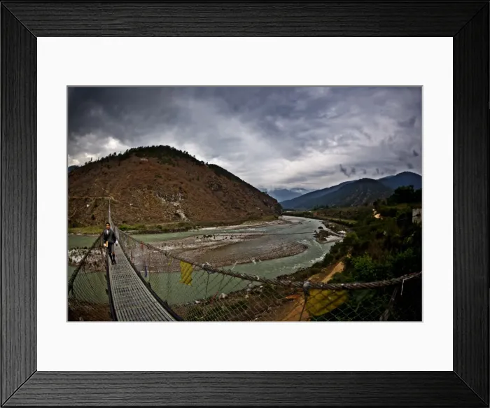 Framed Print : A student crosses Bhutans longest suspension bridge, Panakha, Bhutan Framed Print : A student crosses Bhutans longest suspension bridge, Panakha, Bhutan