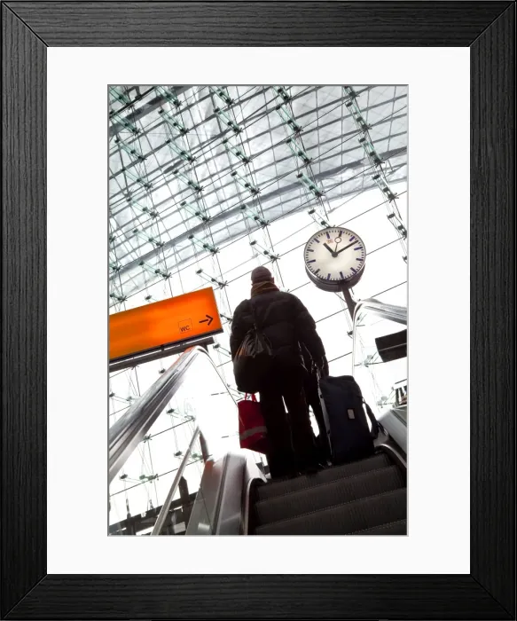 Framed Print : Passenger on escalator and platform clock at modern train station, Berlin Framed Print : Passenger on escalator and platform clock at modern train station, Berlin