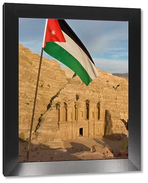 The Jordanian flag in front of Al Deir (the Monastery) at sunset, Petra
