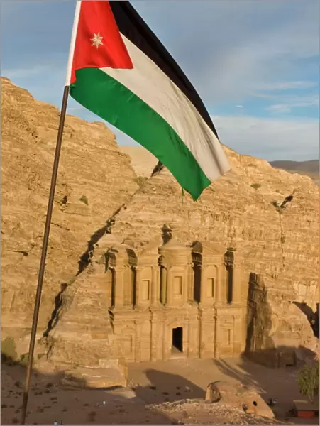 The Jordanian flag in front of Al Deir (the Monastery) at sunset, Petra