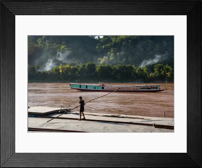 Framed Print : Young sailor on the roof of two boats, Luang Prabang, Laos, Indochina, Southeast Asia Framed Print : Young sailor on the roof of two boats, Luang Prabang, Laos, Indochina, Southeast Asia