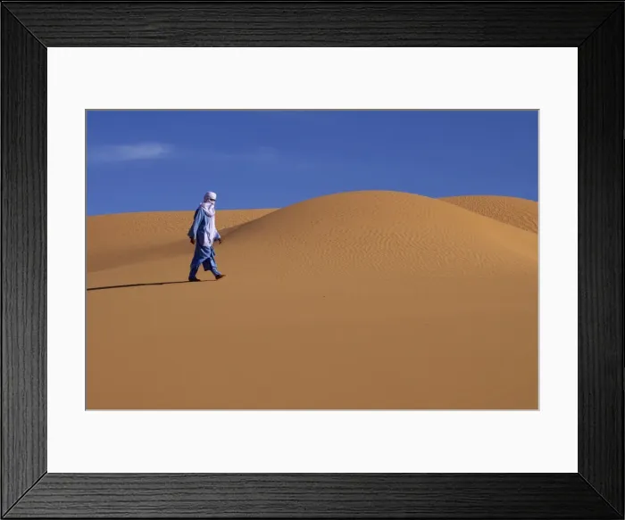 Framed Print : A Tuareg walking on a dune of the erg of Uan Kaza in the Fezzan desert Framed Print : A Tuareg walking on a dune of the erg of Uan Kaza in the Fezzan desert