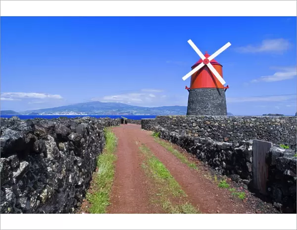 Windmill in lava vineyards with Faial in distance, Pico, Azores, Portugal, Europe