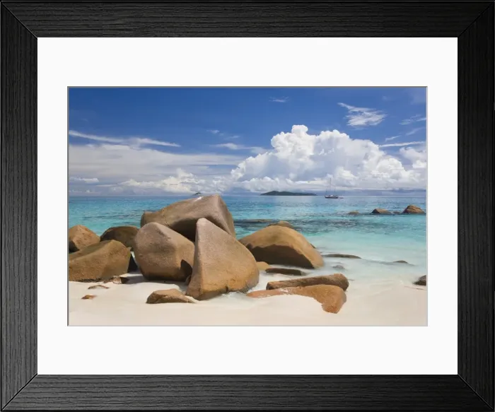 Framed Print : Granite boulders on the shore at Anse Lazio, island of Aride visible on horizon Framed Print : Granite boulders on the shore at Anse Lazio, island of Aride visible on horizon