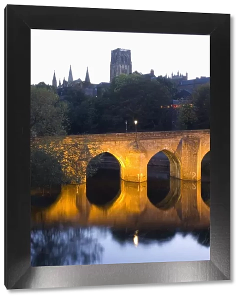 The River Wear and Elvet Bridge illuminated by night, the cathedral on hillside beyond