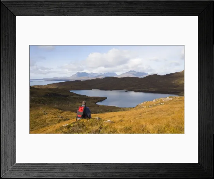 Framed Print : Hiker looking across Loch Dhughaill towards the distant Cuillin Hills, Sleat Peninsula Framed Print : Hiker looking across Loch Dhughaill towards the distant Cuillin Hills, Sleat Peninsula