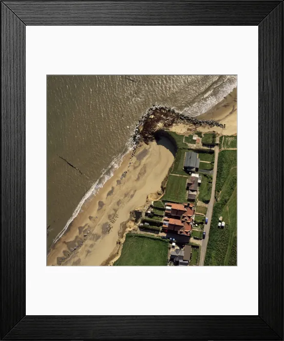 Framed Print : Aerial view of Happisburgh, showing precarious position of several houses as cliffs are eroded by coastal erosion, Norfolk, England, United Framed Print : Aerial view of Happisburgh, showing precarious position of several houses as cliffs are eroded by coastal erosion, Norfolk, England, United