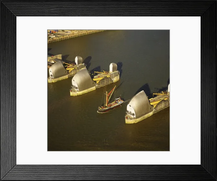 Framed Print : Aerial image of Thames sailing barge and Thames Flood Barrier across the River Thames Framed Print : Aerial image of Thames sailing barge and Thames Flood Barrier across the River Thames