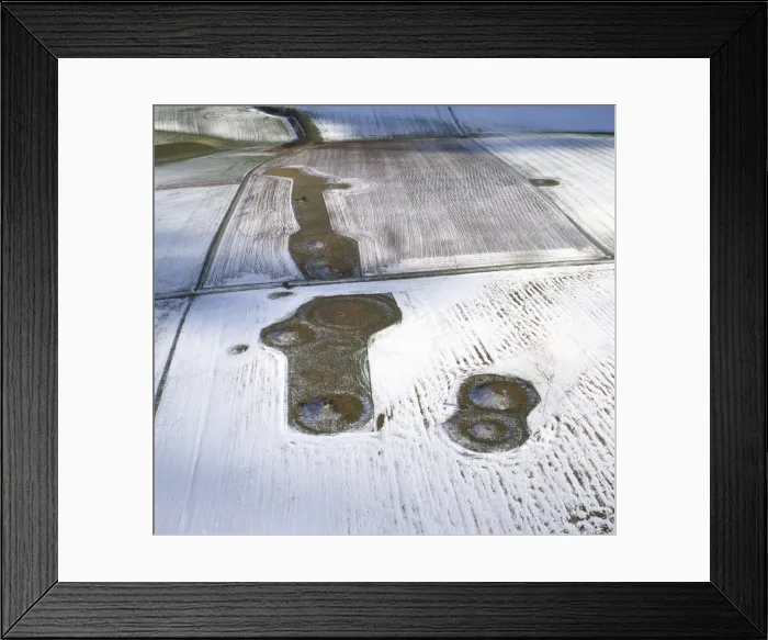 Framed Print : Aerial image of Normanton Down Barrows in snow, consisting of a Neolithic long barrow