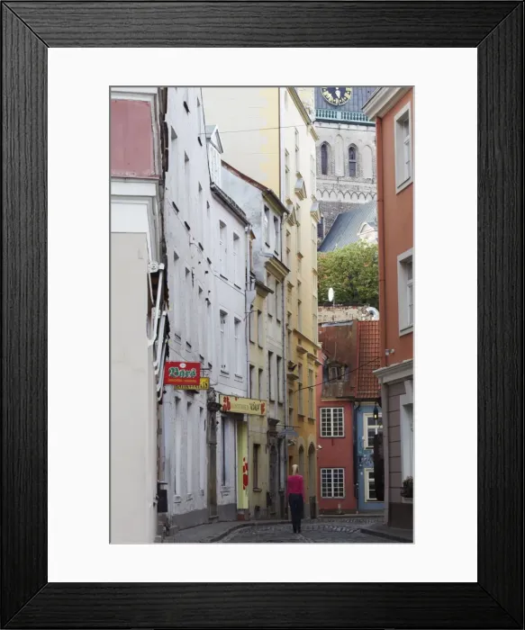Framed Print : Woman walking along street In Old Town, Riga, Latvia, Baltic States, Europe Framed Print : Woman walking along street In Old Town, Riga, Latvia, Baltic States, Europe