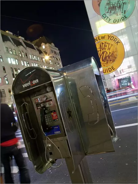 Pay phone and shop windows on Fifth Avenue at night, Manhattan, New York City