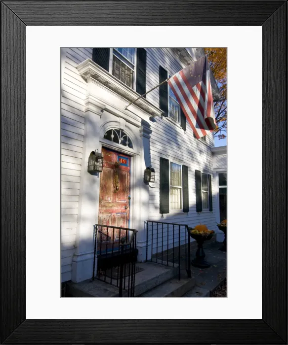 Framed Print : American flag hanging above an old style house, Chester, Connecticut, New England Framed Print : American flag hanging above an old style house, Chester, Connecticut, New England