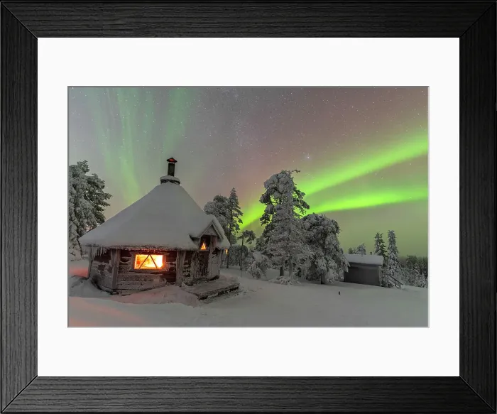 Framed Print : Shades of green color the Northern Lights (Aurora Borealis) above a snowy landscape with a typical hut lit by a fire inside in the foreground, Finnish Lapland, Finland, Europe Framed Print : Shades of green color the Northern Lights (Aurora Borealis) above a snowy landscape with a typical hut lit by a fire inside in the foreground, Finnish Lapland, Finland, Europe