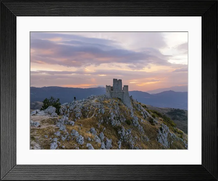 Framed Print : A person admires the Rocca Calascio castle during an autumn sunrise, National Park of Gran Sasso and Monti of Laga, Abruzzo, Italy, Europe Framed Print : A person admires the Rocca Calascio castle during an autumn sunrise, National Park of Gran Sasso and Monti of Laga, Abruzzo, Italy, Europe