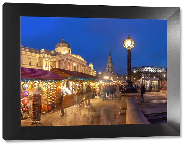 View of Christmas market and The National Gallery in Trafalgar Square at dusk, Westminster, London, England, United Kingdom, Europe