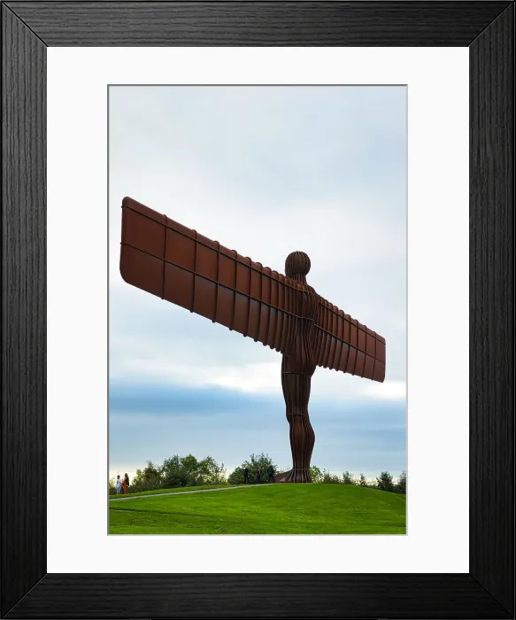 Framed Print : Large angel sculpture with outstretched wings against a cloudy sky, symbolizing hope and freedom