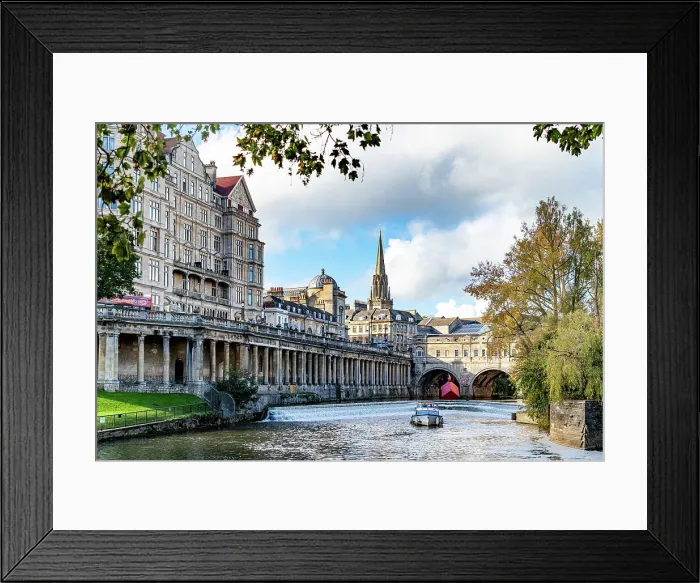 Framed Print : Picturesque view of historic city with River Avon, boat, and classic architecture under a cloudy sky, Bath, Somerset, England, United Kingdom, Europe Framed Print : Picturesque view of historic city with River Avon, boat, and classic architecture under a cloudy sky, Bath, Somerset, England, United Kingdom, Europe