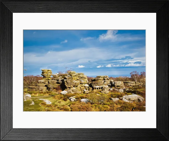 Framed Print : Picturesque rocky landscape with unique rock formations under a blue sky with fluffy clouds at Brimham Rocks, in North Yorkshire Framed Print : Picturesque rocky landscape with unique rock formations under a blue sky with fluffy clouds at Brimham Rocks, in North Yorkshire