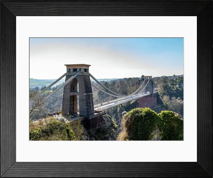 Framed Print : Clifton Suspension Bridge with towers against a clear sky, surrounded by greenery in Bristol, England, United Kingdom, Europe Framed Print : Clifton Suspension Bridge with towers against a clear sky, surrounded by greenery in Bristol, England, United Kingdom, Europe