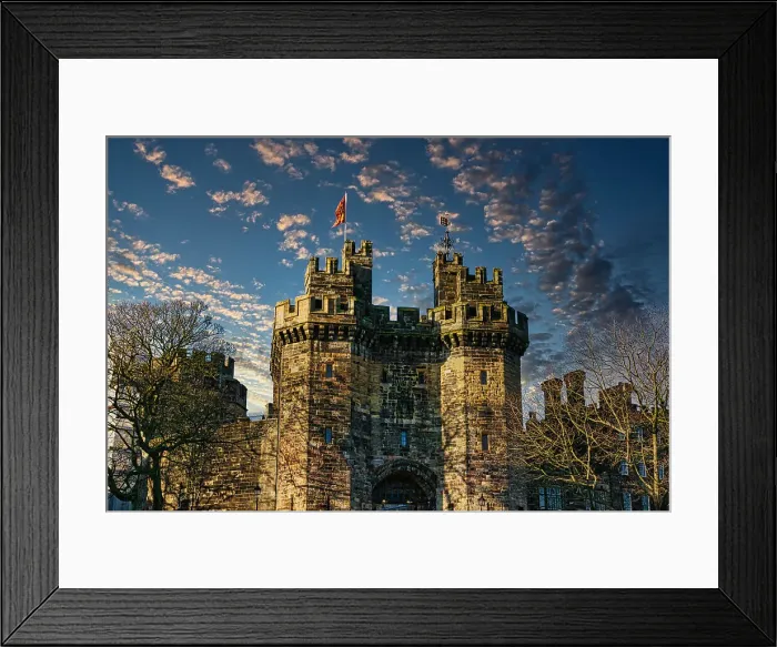 Framed Print : Historic stone castle with towers against a blue sky with scattered clouds at sunset in Lancaster