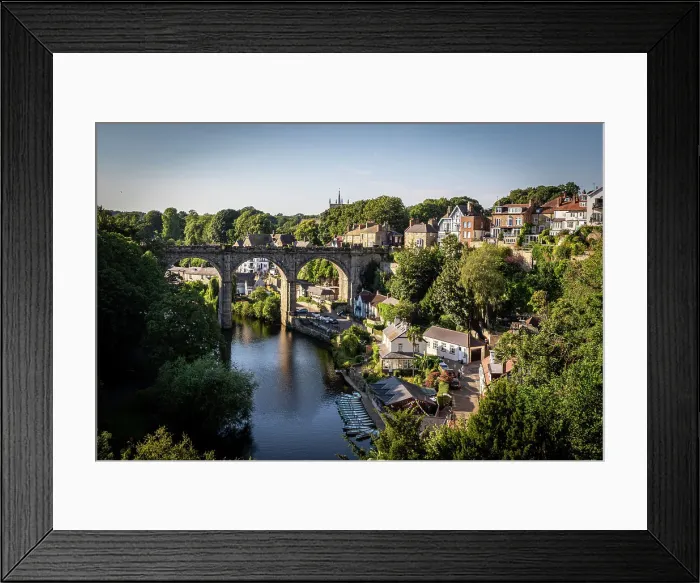 Framed Print : Scenic view of an old arched bridge over a tranquil River Nidd with surrounding greenery and houses in a quaint village in Knaresborough, North Yorkshire, England, United Kingdom, Europe Framed Print : Scenic view of an old arched bridge over a tranquil River Nidd with surrounding greenery and houses in a quaint village in Knaresborough, North Yorkshire, England, United Kingdom, Europe