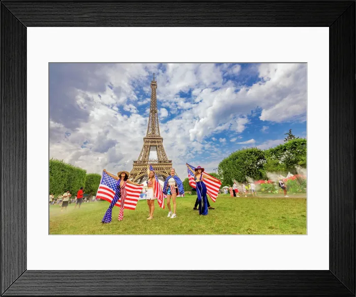 Framed Print : Patriotic American Woman jumping and cheering for Team USA and the Paris 2024 Olympics in front of the Eiffel Tower beach volleyball stadium, Paris, France, Europe Framed Print : Patriotic American Woman jumping and cheering for Team USA and the Paris 2024 Olympics in front of the Eiffel Tower beach volleyball stadium, Paris, France, Europe