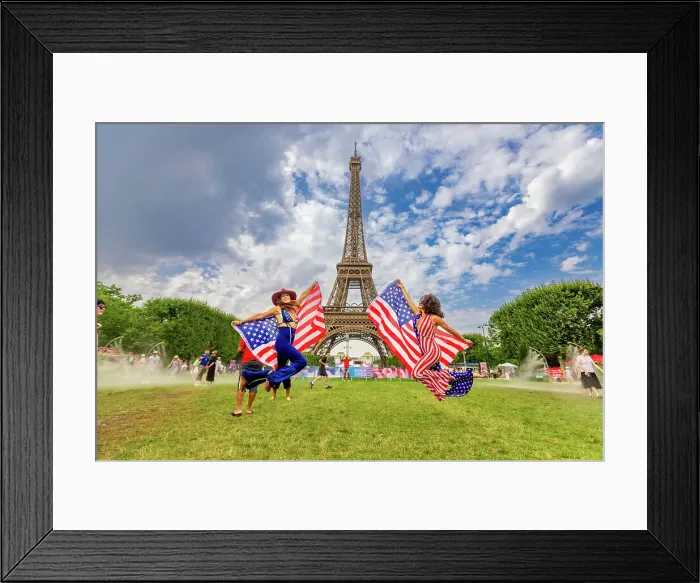 Framed Print : Patriotic American Woman jumping and cheering for Team USA and the Paris 2024 Olympics in front of the Eiffel Tower beach volleyball stadium, Paris, France, Europe Framed Print : Patriotic American Woman jumping and cheering for Team USA and the Paris 2024 Olympics in front of the Eiffel Tower beach volleyball stadium, Paris, France, Europe