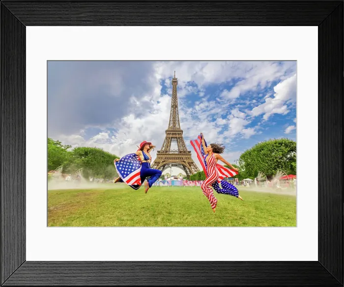 Framed Print : Patriotic American Woman jumping and cheering for Team USA and the Paris 2024 Olympics in front of the Eiffel Tower beach volleyball stadium, Paris, France, Europe Framed Print : Patriotic American Woman jumping and cheering for Team USA and the Paris 2024 Olympics in front of the Eiffel Tower beach volleyball stadium, Paris, France, Europe