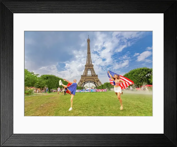 Framed Print : Patriotic American Woman jumping and cheering for Team USA and the Paris 2024 Olympics in front of the Eiffel Tower beach volleyball stadium, Paris, France, Europe Framed Print : Patriotic American Woman jumping and cheering for Team USA and the Paris 2024 Olympics in front of the Eiffel Tower beach volleyball stadium, Paris, France, Europe