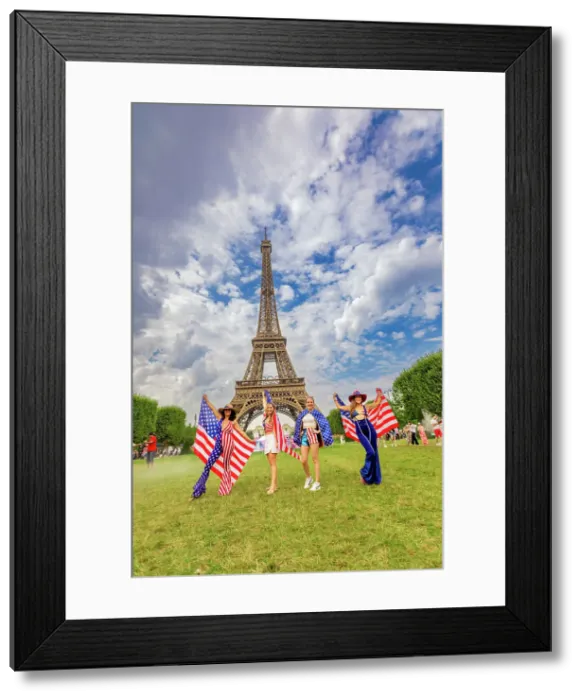 Framed Print : Patriotic American Woman jumping and cheering for Team USA and the Paris 2024 Olympics in front of the Eiffel Tower beach volleyball stadium, Paris, France, Europe Framed Print : Patriotic American Woman jumping and cheering for Team USA and the Paris 2024 Olympics in front of the Eiffel Tower beach volleyball stadium, Paris, France, Europe
