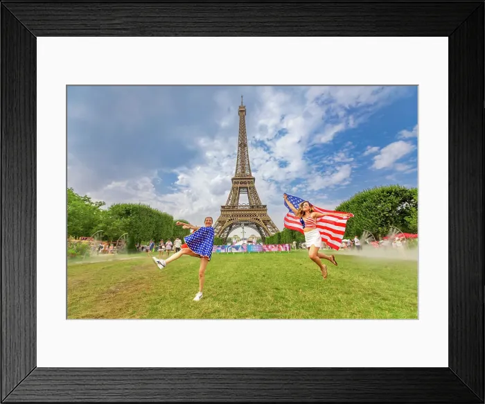 Framed Print : Patriotic American Woman jumping and cheering for Team USA and the Paris 2024 Olympics in front of the Eiffel Tower beach volleyball stadium, Paris, France, Europe Framed Print : Patriotic American Woman jumping and cheering for Team USA and the Paris 2024 Olympics in front of the Eiffel Tower beach volleyball stadium, Paris, France, Europe