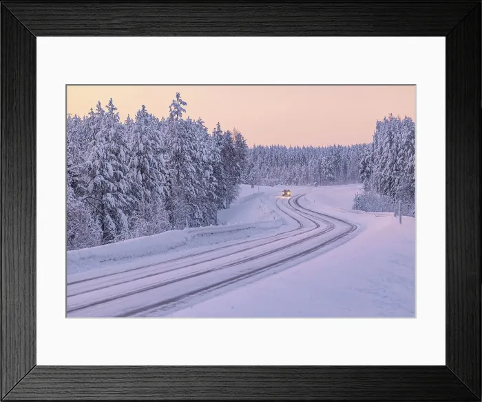 Framed Print : A car driving along a snow-covered road along the Finnish Lapland forest during a winter blue hour, Muonio, Finland, Europe Framed Print : A car driving along a snow-covered road along the Finnish Lapland forest during a winter blue hour, Muonio, Finland, Europe