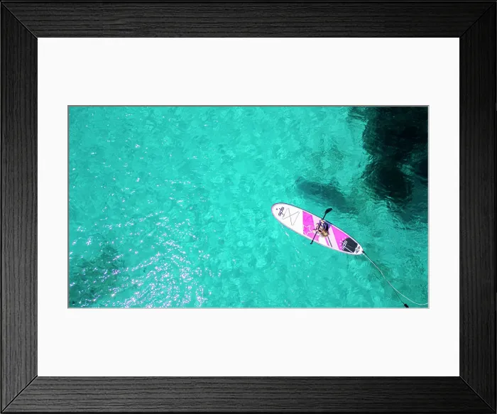 Framed Print : Aerial of a young girl paddling on a SUP on the Formentor Peninsula, Mallorca, Balearic islands, Spain, Mediterranean, Europe Framed Print : Aerial of a young girl paddling on a SUP on the Formentor Peninsula, Mallorca, Balearic islands, Spain, Mediterranean, Europe