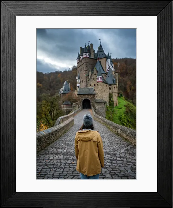 Framed Print : Back view of young woman with yellow jacket looking at Eltz medieval historic castle in an autumn landscape with trees at sunrise, Wierschem, Rhineland-Palatinate, Germany, Europe Framed Print : Back view of young woman with yellow jacket looking at Eltz medieval historic castle in an autumn landscape with trees at sunrise, Wierschem, Rhineland-Palatinate, Germany, Europe