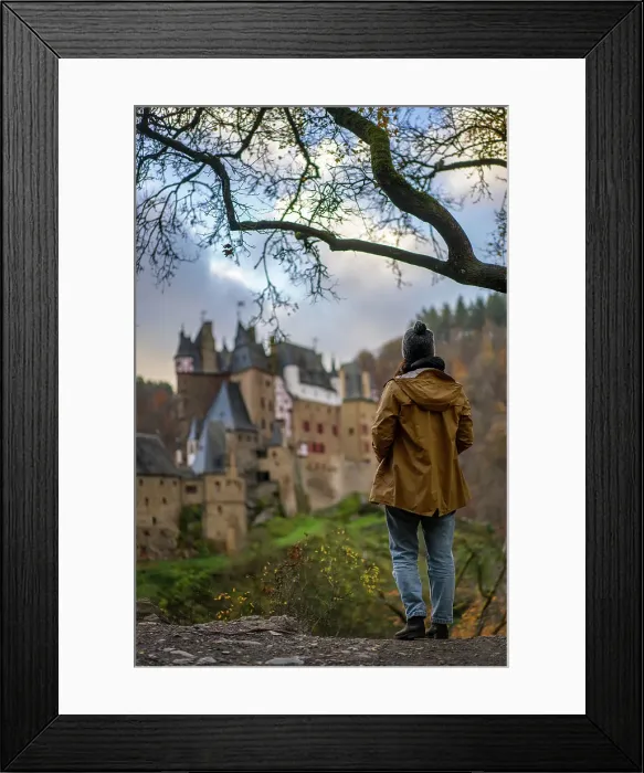 Framed Print : Back view of young woman with yellow jacket looking at Eltz medieval historic castle in an autumn landscape with trees at sunrise, Wierschem, Rhineland-Palatinate, Germany, Europe Framed Print : Back view of young woman with yellow jacket looking at Eltz medieval historic castle in an autumn landscape with trees at sunrise, Wierschem, Rhineland-Palatinate, Germany, Europe