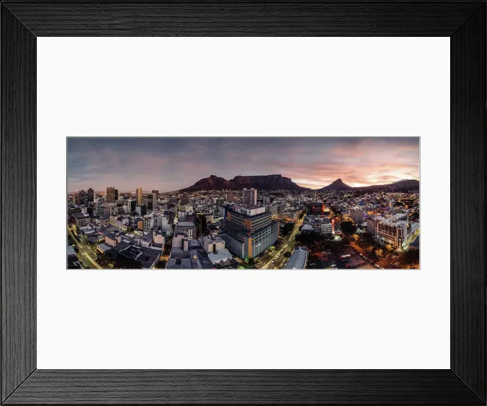 Framed Print : Aerial drone panoramic view of the cityscape as dusk sets in, highlighting the downtown buildings with a warm glow against the silhouette of Table Mountain and Lion's Head, Cape Town, Western Cape, South Africa, Africa Framed Print : Aerial drone panoramic view of the cityscape as dusk sets in, highlighting the downtown buildings with a warm glow against the silhouette of Table Mountain and Lion's Head, Cape Town, Western Cape, South Africa, Africa