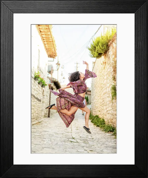 Framed Print : Woman jumping on the street in Berat, Albania, Europe
