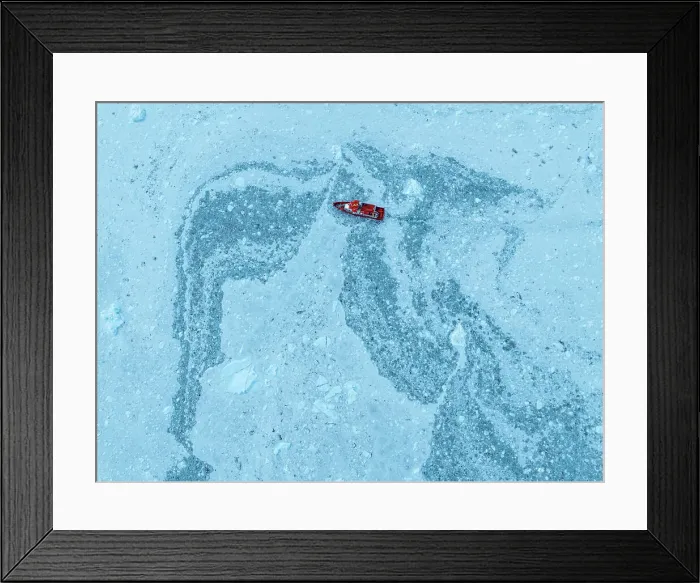 Framed Print : Aerial of a little ship floating between the ice below the Eqi glacier, Western Greenland, Denmark, Polar Regions Framed Print : Aerial of a little ship floating between the ice below the Eqi glacier, Western Greenland, Denmark, Polar Regions
