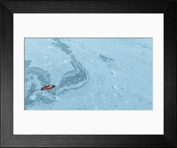 Framed Print : Aerial of a little ship floating between the ice below the Eqi glacier, Western Greenland, Denmark, Polar Regions Framed Print : Aerial of a little ship floating between the ice below the Eqi glacier, Western Greenland, Denmark, Polar Regions