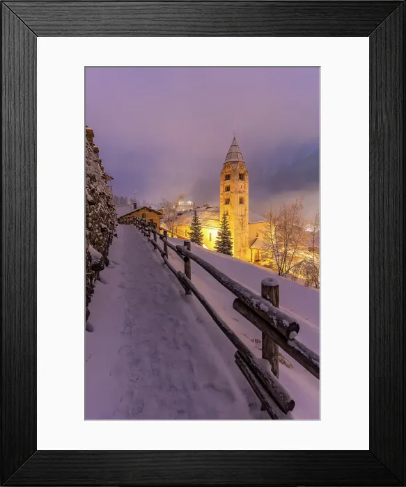 Framed Print : Church of Saint Pantalon and snow covered town centre and mountainous background in winter at dusk, Courmayeur, Aosta Valley, Italian Alps, Italy