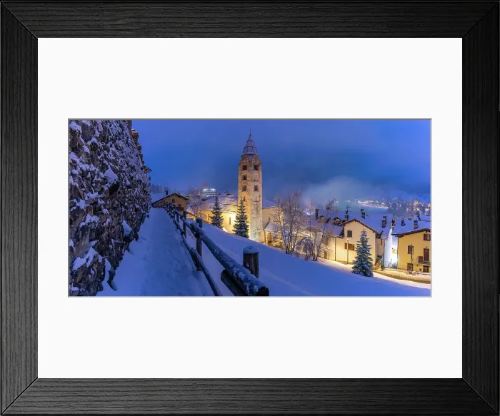 Framed Print : Church of Saint Pantalon and snow covered town centre and mountainous background in winter at dusk, Courmayeur, Aosta Valley, Italian Alps, Italy